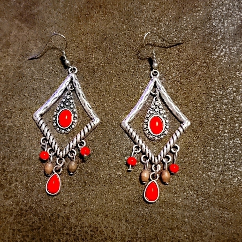 Silver tone jewelry earrings. Dangling orange & brown accents